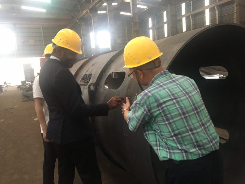 Technical team gathered around installed extraction equipment
