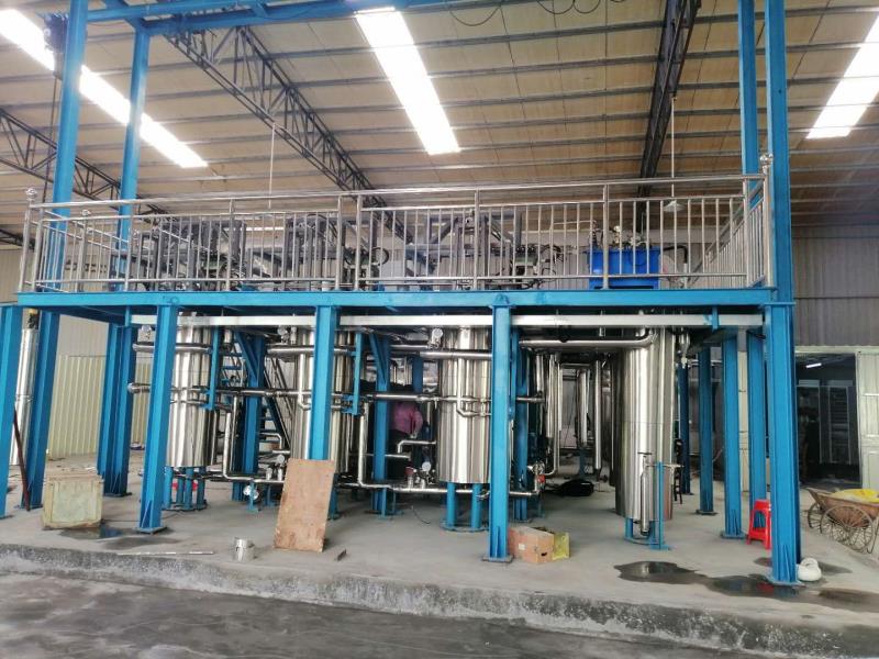 Team inspecting fabricated vessel sections in manufacturing facility
